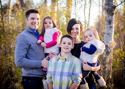 Happy family standing outside