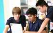 Students at a computer collaborating on learning