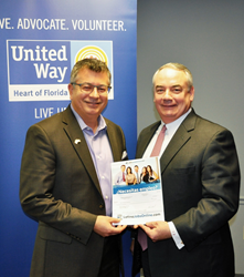 Robert Newland, CEO/Founder of LatinoJobsOnline.com presenting check to Jeff Hayward, President of Heart of Florida United Way