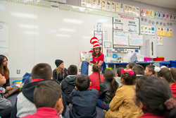 Deanne Mendoza, Executive VP, reads to students