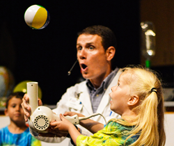 CDM educators are experts in explaining complex STEM concepts to young students. Lucien Scott, science assistant manager, demonstrates the Bernoulli principle to a young student.