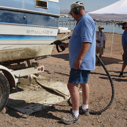 A person demonstrating a way to clean a boat after being in infected waters.