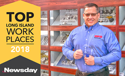 Robert Kufner President and CEO of Designatronics holding the Top companies Award from Newsday