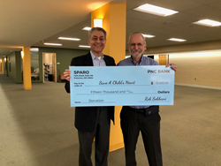Sparo's Rob Sobhani (L) presents $15,000 check to Rabbi David Litwack (R) for Save A Child's Heart