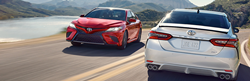 red and white 2019 Camrys driving past each other