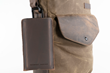 Executive Leather iPhone Sleeve — full-grain "chocolate" leather attached to bag with optional carabiner