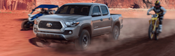 Grey 2019 Toyota Tacoma driving in dirt.