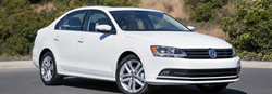2017 Volkswagen Jetta driving down a road
