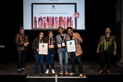 six people in a stage. Four people holding two certificates