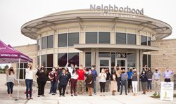 Group of people lined up cheering in front of the new Neighborhood Credit Union building in Anna, TX.