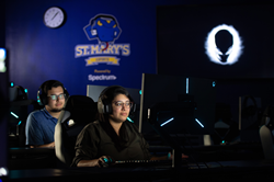 St. Mary's University Esports Head Coach Kaitlin Teniente in the foreground and Assistant Coach Mack Moncada test drive the new St. Mary's Esports Arena.