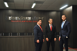 Steigner, Greene and Feiner Stand in their custom court room made for practice trials.