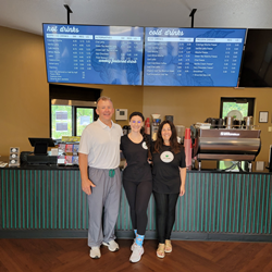 Stevenson family members stand in front of coffee bar at their new Coffee Cravings coffee shop in Yorktown, Indiana