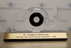 Clear acrylic award for Dr. Parkhurst after completing the IC-8 study sitting on desk, blurry background