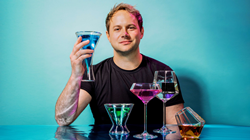 Picture of Founder & CEO Matt Rollens with Dragon Glassware products