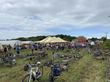 Riders stow their bikes in a field at a farm tour during Bike The Barns.