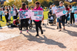Advocates march on the National Mall carrying signs with stillbirth facts.