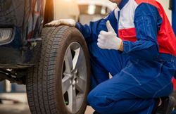Man fixing the tire of a vehicle
