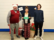 L to R: Andrew Jackson (Doe Run) delivers gifts and gift cards to the Adopt-A-Family program at Viburnum High School to students Jorja Conaway, FBLA President, and Gabe Brooks, FBLA Treasurer.