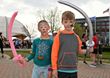 Two kids with painted faces and balloons pose for a picture at last year’s Zeigler Kalamazoo Marathon event