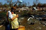 A New Orleans couple in front of their home lost in Hurricane Katrina.