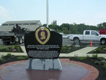 The dedication plaque is inscribed with the motto of the Purple Heart Order