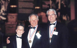 Thomas Stankovich with a medalist friend and his son