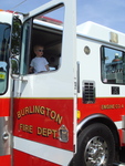 Minor, 3, rides in the Burlington Fire Department truck at Mackintosh on the Lake&#039;s Child Safety Day.