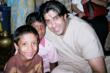 Hassan Akmal, M.P.H., posing with children inside a tsunami shelter in India