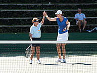 Tennis Hall of Famer Lindsay Davenport and avid tennis fan come together on center court at the Wailea Tennis Fantasy Camp