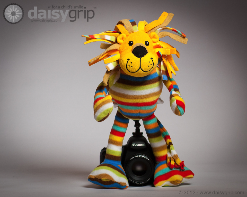 Elvis Lion stuffed animal supported by the DaisyGrip™