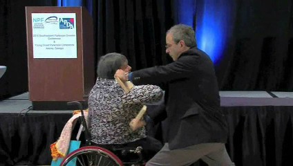 Author Speaker Richard London teaching a wheelchair patient to break a board