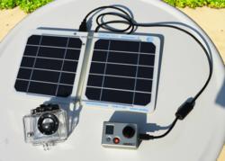 The sCarger-5 solar charger charging a GoPro camera