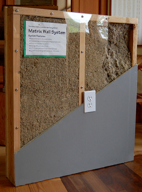 A layered polyiso wall system includes wet-sprayed or netted dense-pack cellulose.