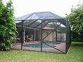 A screen pool enclosure by Venetian Builders, Inc., of Miami. Pool screens, which can get the family outdoors by making the pool more comfortable, can help minimize indoor crowding.