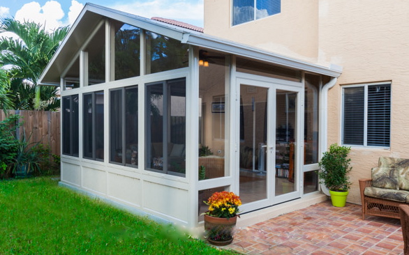 A Venetian Builders, Inc., sunroom is designed to conform to the proportions of the two-story house it expands.