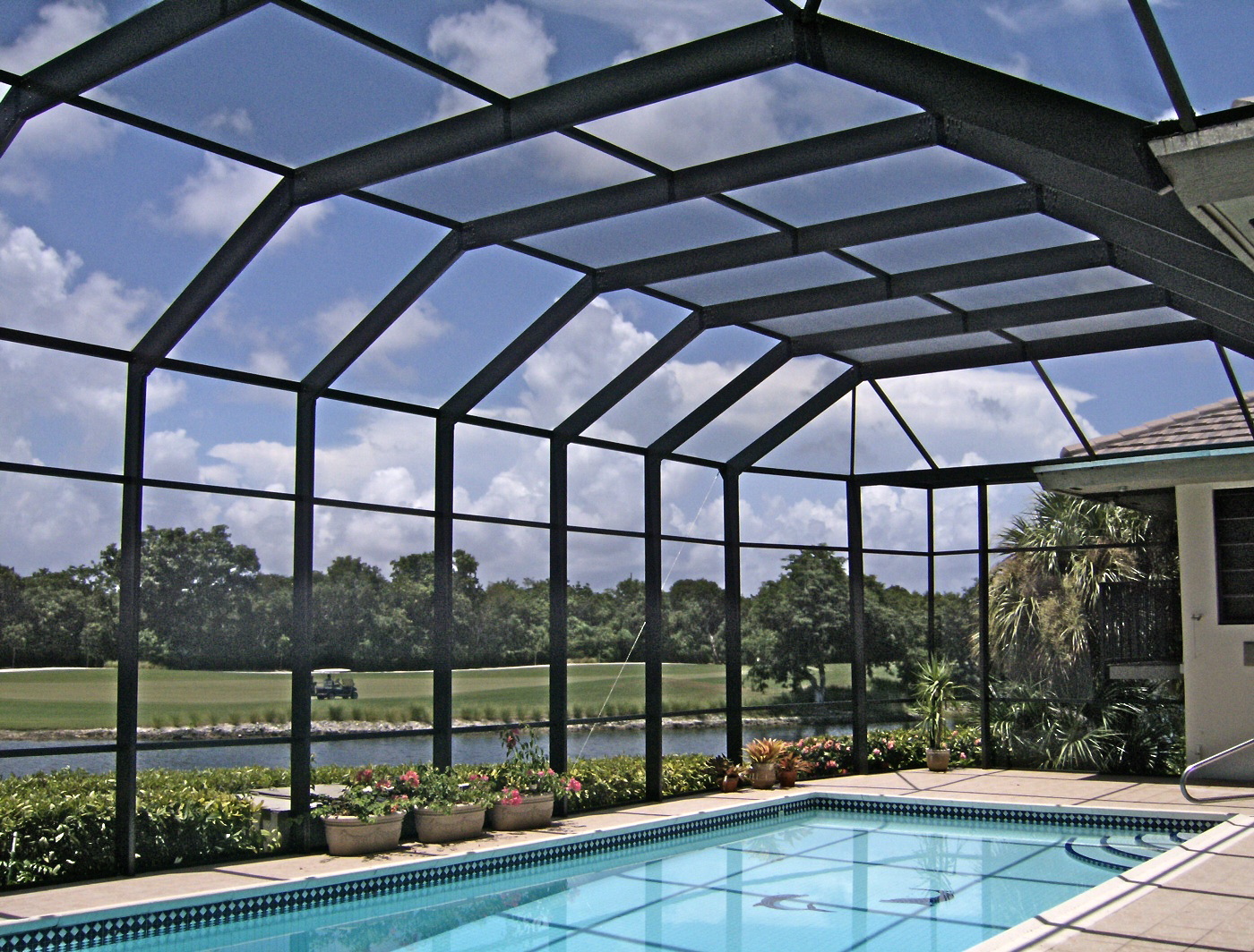 A screened pool enclosure from Venetian Builders, Inc., Miami. Screens protect from insects, other pests and even errant golf balls but preserve views, ventilation and sunlight.