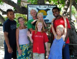 Bridge the Gap Villages co-founders, Jenny and Jimmy Cahill, with their children, Lucas, Oliver and Bethany, flanked by Fijian friends, Nemani and Boso on Vorovoro Island in Fiji