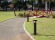 Reliance Foundry’s model R-9810 solar bollards line a pathway that leads to bridge in a park
