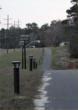 A row of solar-powered lighting bollards by Reliance Foundry runs alongside a back-country road