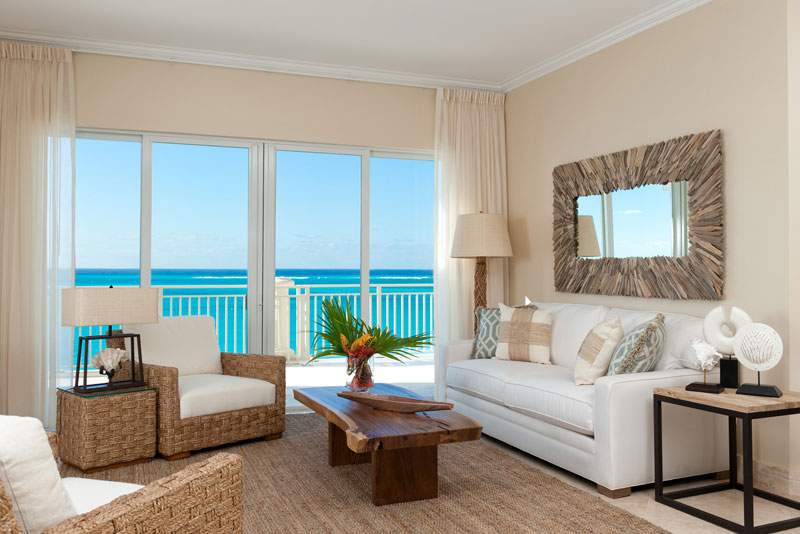 Beautifully furnished living rooms offer oceanfront views of Grace Bay.