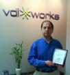 “VDIworks CEO, Amir Husain, holding the SBCA Best of Business award”