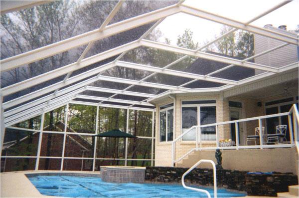 A screen swimming pool enclosure by Venetian Builders, Inc., Miami. Screen enclosures help homeowners keep out bugs, plant debris and other nuisances.