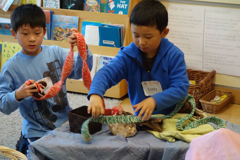 Boys having fun setting up their own story theater, using baben made from all-natural wool