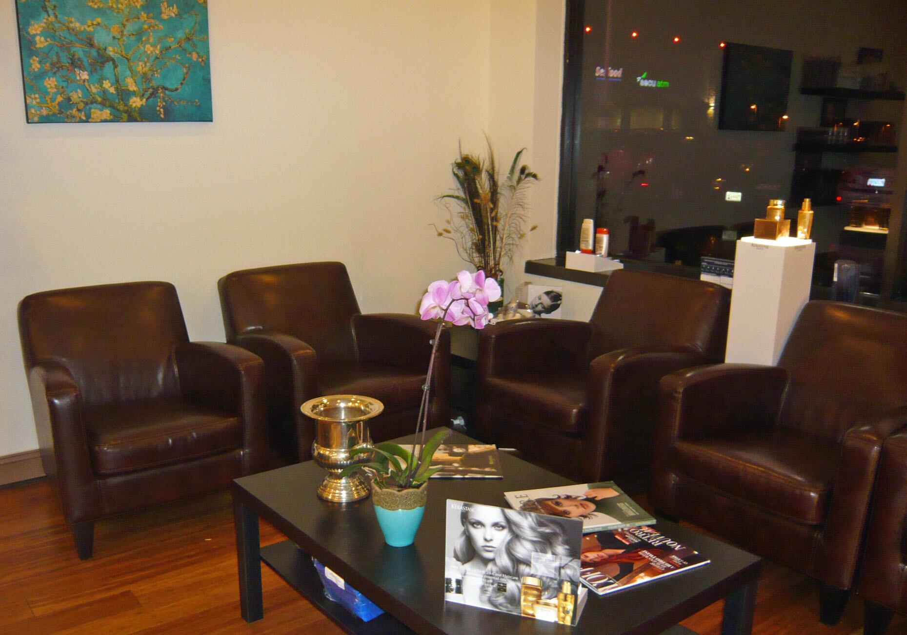 Salon Craft waiting lounge, where clients enjoy refreshments in comfortable leather chairs.  Styling guides placed throughout the space help to inspire the perfect look.