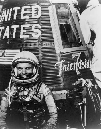 Nearly 20 years after his WWII service as a marine fighter pilot, astronaut John Glenn grins outside his Friendship 7 capsule on February 20, 1962. NATIONAL ARCHIVES