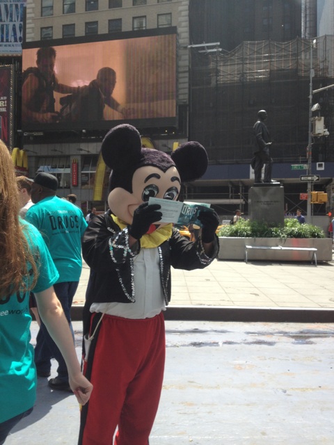 On Times Square June 29, 2013, “Mickey Mouse” studied a copy of The Truth About Drugs booklet, a gift from a Scientologist promoting drug-free living.