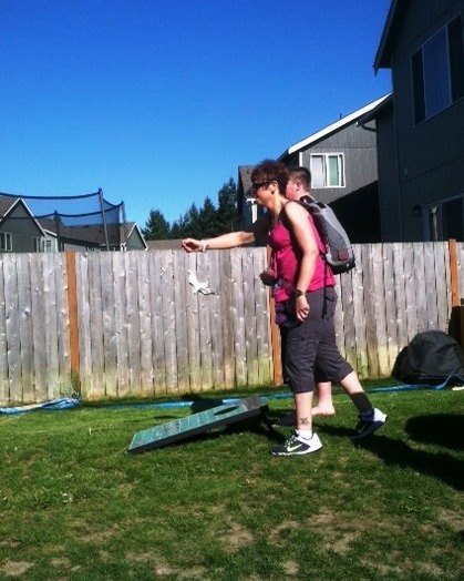Stacie Sumandig plays cornhole in her backyard wearing the Freedom® portable driver that powers her SynCardia Total Artificial Heart in the Backpack. She received her matching donor heart on May 21, 2013.