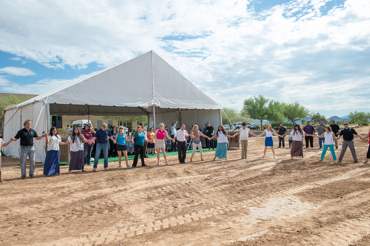 TopGolf at Riverwalk groundbreaking ceremony attendees join hands to participate in a Salt River Pima-Maricopa Indian Community traditional dance