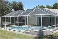 A screen pool enclosure from Venetian Builders, Inc., Miami. Pool screens make swimming and sunbathing bug-free.